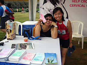 Persis and runner at table of handmade cards and brochures. Cards for a Cause