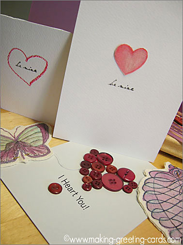 Hearts, red buttons, stamped fabric swirled heart and butterfly coloured in with permanent ink for these valentines cards. Valentine Card Ideas - Inspiration to Jumpstart Your Happy Valentines Card projects.